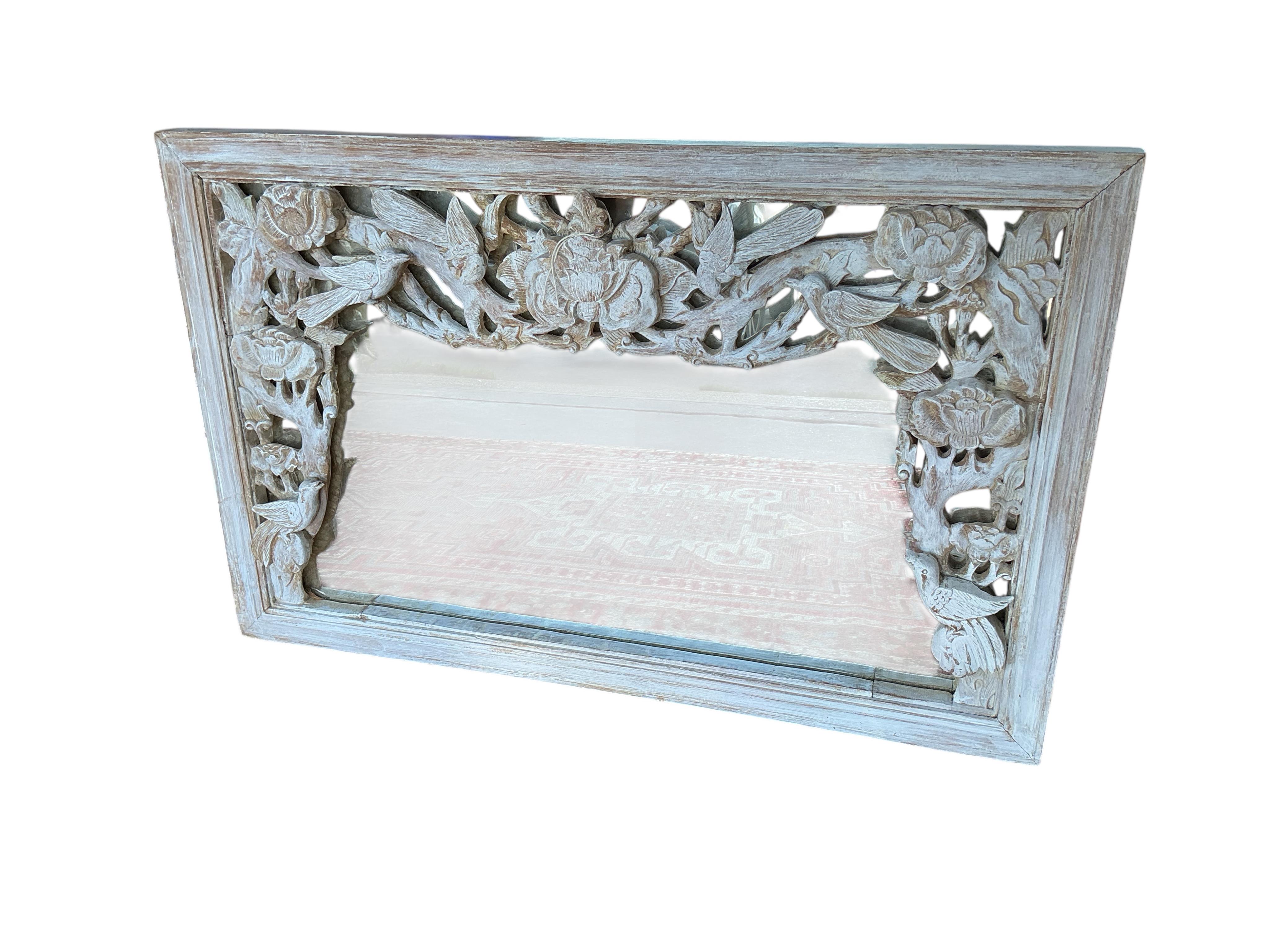 A Chinese carved hardwood wall mirror, later painted, width 93cm, height 60cm